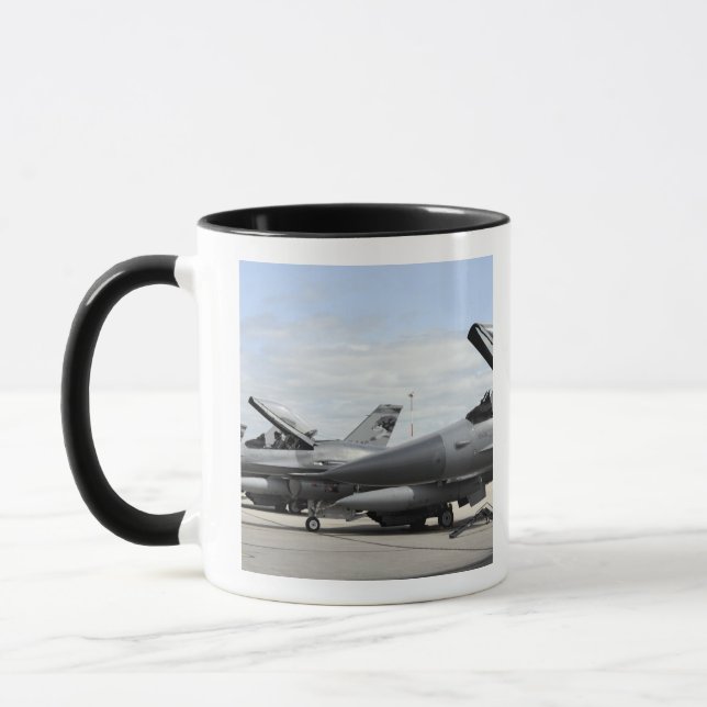 F-16 Fighting Falcons await to launch Mug (Left)