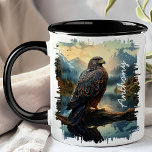 Falcon in Mountain Wilderness Mug<br><div class="desc">Embrace the majesty of nature with the Falcon in Mountain Wilderness Mug. This striking mug features a detailed image of a falcon perched on a branch, set against a backdrop of rugged mountains and dense forests. Customized with your name, it adds a personal touch that makes it uniquely yours. Perfect...</div>