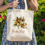 Fall botanical bouquet bridesmaid name tote bag<br><div class="desc">Modern rustic bridesmaid tote bag gift featuring autumn fall rusty orange gold and ivory cream flowers with dried leaves and foliage and a whimsical chic typography script.             Personalize it with her name on the front side and with the wedding couple's names and date on the reverse.</div>