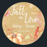 Fall in Love Autumn Leaf Yellow Wedding Monogram Classic Round Sticker<br><div class="desc">"Fall in Love" rustic themed wedding favour stickers feature orange and golden autumn foliage, a fall watercolor pumpkin and customizable monogram of the bride and groom's names and wedding date on an autumn leaf yellow background. Exclusively designed for you by Happy Dolphin Studio. If you need any help or matching...</div>