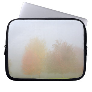 Fall trees shrouded in mist laptop sleeve