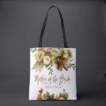 Fall wedding floral modern mother of the bride tote bag<br><div class="desc">Modern rustic mother of the bride typography tote bag featuring autumn fall rusty orange gold and ivory cream flowers with dried leaves and foliage and a whimsical chic script.             Personalize it with mother's name on the front side and with the wedding couple names and date on the reverse.</div>