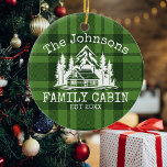 Family Cabin Green Plaid Themed Name Personalized Ceramic Ornament<br><div class="desc">Ideal for family gatherings, reunions, or your mountain retreat, this product is designed with a charming green plaid background. It showcases a beautifully designed mountain scene with cabin surrounded by trees, personalized with your family name, the year established, and any additional details you prefer. An excellent choice for a thoughtful...</div>