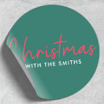 Family Christmas | Stylish Trendy Forest Green Classic Round Sticker<br><div class="desc">Simple,  stylish "Christmas with the <your name="">" quote stickers in modern minimalist typography in festive red and white on a green background. The design can be easily personalized with your family name(s),  year or own special greeting for super cute bespoke holiday vibes!</your></div>