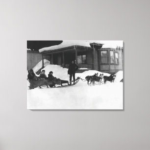 Family travelling by Dog Sled in Alaska Canvas Print