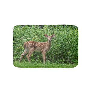 Fawn in front of a fence bath mat