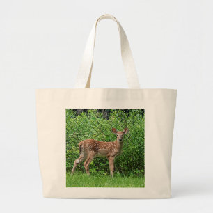 Fawn in front of a fence large tote bag