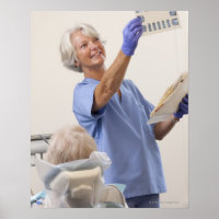 Female dental hygienist examining an X-Ray