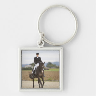 female dressage rider exercising keychain