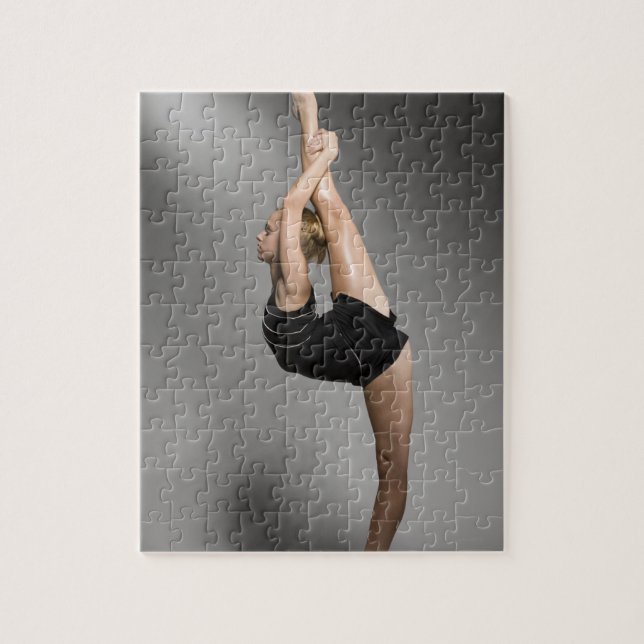 Female gymnast stretching, studio shot jigsaw puzzle (Vertical)