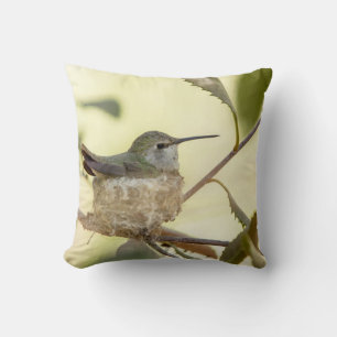Female hummingbird on her nest throw pillow
