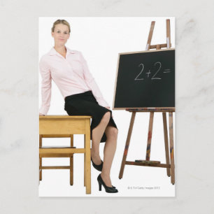 Female Teacher Posing by Wooden Desk Postcard