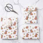 Festive Capybara Christmas Holiday Wrapping Paper Sheet<br><div class="desc">This Festive Capybara Holiday Wrapping Paper brings joy and charm to your gift-giving. Featuring a delightful pattern of capybaras adorned with Santa hats, surrounded by vibrant oranges, this wrapping paper is perfect for the holiday season. The playful and unique design adds a touch of fun to any present, making it...</div>