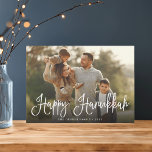 Festive Script Overlay Hanukkah Photo Holiday Card<br><div class="desc">Simple and chic Hanukkah photo card features your favourite family photo overlaid with "Happy Hanukkah" in white modern script lettering. Personalize with your family name and the year along the bottom. Cards reverse to a snow and stars pattern in rich navy blue and white.</div>