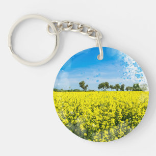 Field with yellow flowers and blue sky keychain