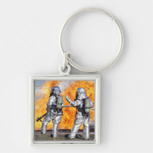 Firefighters battle a simulated fire keychain