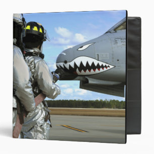 Firefighters deploy a fire hose during a drill binder