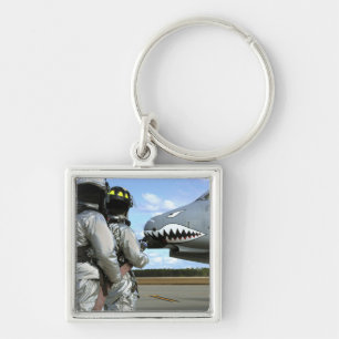 Firefighters deploy a fire hose during a drill keychain