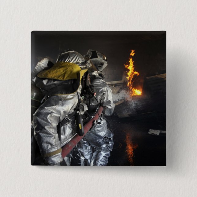 Firefighters extinguish a fire in a training ro 2 inch square button (Front)