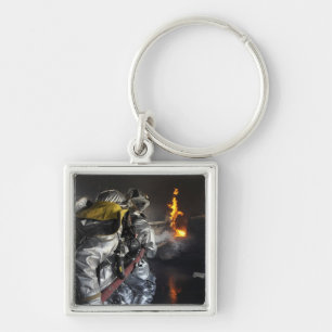 Firefighters extinguish a fire in a training ro keychain
