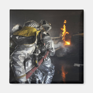 Firefighters extinguish a fire in a training ro magnet