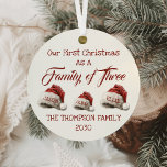 First Christmas As A Family Of Three Personalized Metal Ornament<br><div class="desc">Celebrate the joy of your First Christmas As A Family Of Three with this beautifully crafted Personalized Metal Ornament. Featuring charming Santa hats and a vintage script typeface, this ornament is the perfect way to commemorate the start of your family's holiday traditions. Whether you're welcoming a newborn or cherishing the...</div>