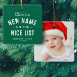 First Christmas baby photo cute green Ceramic Ornament<br><div class="desc">There's a new name on the nice list! Celebrate and remember baby's first Christmas with this cute one-photo personalized ornament. The front features a sweet type treatment on a green background with room for name and birth date and the back has a large photo. This keepsake ornament makes a great...</div>