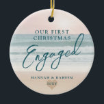 First Christmas Beach Engagement Ocean Pastel Ceramic Ornament<br><div class="desc">Keepsake Engagement Ornament a pastel pink peach and teal blue beach sunset or sunrise over a tropical ocean coastline sand shoreline is perfect for the couple who got engaged on a beach or are planning a destination wedding.</div>
