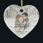 First Christmas Engaged Custom Photo Black Script Ceramic Ornament<br><div class="desc">Commemorate your engagement with this beautiful heart-shaped keepsake ornament. The black text reads "Our first Christmas engaged, " with the word "engaged" in elegant handwriting script with flourishes before and after. Replace the sample image with your favorite photo, and add your names and the year. A white gradient filter helps...</div>