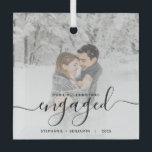 First Christmas Engaged Custom Photo Black Script Glass Ornament<br><div class="desc">Commemorate your engagement with this beautiful modern keepsake ornament. The black text reads "Our first Christmas engaged, " with the word "engaged" in elegant handwriting script with flourishes before and after. Replace the sample image with your favourite photo, and add your names and the year. A white gradient filter helps...</div>