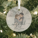 First Christmas Engaged Custom Photo Green Script Glass Ornament<br><div class="desc">Commemorate your engagement with this beautiful modern keepsake ornament. The dark green text reads "Our first Christmas engaged, " with the word "engaged" in elegant handwriting script with flourishes before and after. Replace the sample image with your favourite photo, and add your names and the year. A white gradient filter...</div>