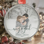 First Christmas Engaged Custom Photo Green Script Metal Ornament<br><div class="desc">Commemorate your engagement with this beautiful modern keepsake ornament. The green text reads "Our first Christmas engaged, " with the word "engaged" in elegant handwriting script with flourishes before and after. Replace the sample image with your favourite photo, and add your names and the year. A white gradient filter helps...</div>