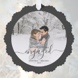 First Christmas Engaged Custom Photo Grey Script Ornament Card<br><div class="desc">Commemorate your engagement with this beautiful keepsake ornament card. The charcoal grey text reads "Our first Christmas engaged, " with the word "engaged" in elegant handwriting script with flourishes before and after. Replace the sample image with your favourite photo, and add your names and the year. A white gradient filter...</div>