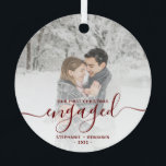 First Christmas Engaged Custom Photo Red Script Metal Ornament<br><div class="desc">Commemorate your engagement with this beautiful modern keepsake ornament. The dark red text reads "Our first Christmas engaged, " with the word "engaged" in elegant handwriting script with flourishes before and after. Replace the sample image with your favourite photo, and add your names and the year. A white gradient filter...</div>