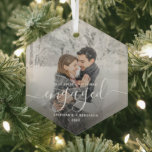 First Christmas Engaged Custom Photo White Script Glass Ornament<br><div class="desc">Commemorate your engagement with this beautiful modern keepsake ornament. The white text reads "Our first Christmas engaged, " with the word "engaged" in elegant handwriting script with flourishes before and after. Replace the sample image with your favourite photo, and add your names and the year. A dark gradient filter helps...</div>