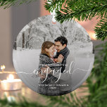 First Christmas Engaged Custom Photo White Script Glass Ornament<br><div class="desc">Commemorate your engagement with this beautiful modern keepsake ornament. The white text reads "Our first Christmas engaged, " with the word "engaged" in elegant handwriting script with flourishes before and after. Replace the sample image with your favourite photo, and add your names and the year. A dark gradient filter helps...</div>