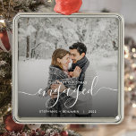 First Christmas Engaged Custom Photo White Script Metal Ornament<br><div class="desc">Commemorate your engagement with this beautiful modern keepsake ornament. The white text reads "Our first Christmas engaged, " with the word "engaged" in elegant handwriting script with flourishes before and after. Replace the sample image with your favourite photo, and add your names and the year. A black gradient filter helps...</div>