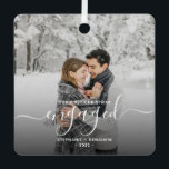 First Christmas Engaged Custom Photo White Script Metal Ornament<br><div class="desc">Commemorate your engagement with this beautiful modern keepsake ornament. The white text reads "Our first Christmas engaged, " with the word "engaged" in elegant handwriting script with flourishes before and after. Replace the sample image with your favourite photo, and add your names and the year. A dark gradient filter helps...</div>