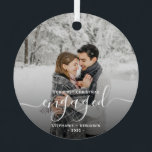 First Christmas Engaged Custom Photo White Script Metal Ornament<br><div class="desc">Commemorate your engagement with this beautiful modern keepsake ornament. The white text reads "Our first Christmas engaged, " with the word "engaged" in elegant handwriting script with flourishes before and after. Replace the sample image with your favourite photo, and add your names and the year. A dark gradient filter helps...</div>