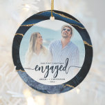 First Christmas Engaged Photo Navy Blue Gold Agate Ceramic Ornament<br><div class="desc">Commemorate your engagement with this beautiful modern keepsake ornament. The navy blue text reads "Our first Christmas engaged, " with the word "engaged" in bold handwriting script with flourishes before and after. Replace the sample image with your favourite photo, and add your names and the year. The photo is framed...</div>