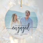 First Christmas Engaged Photo Navy Blue Script Ceramic Ornament<br><div class="desc">Commemorate your engagement with this beautiful modern keepsake ornament. The navy blue text reads "Our first Christmas engaged, " with the word "engaged" in bold handwriting script with flourishes before and after. Replace the sample image with your favourite photo, and add your names and the year. A white gradient filter...</div>