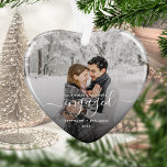 First Christmas Engaged Photo White Script Heart Ornament<br><div class="desc">Commemorate your engagement with this beautiful heart-shaped keepsake ornament. The white text reads "Our first Christmas engaged, " with the word "engaged" in elegant handwriting script with flourishes before and after. Replace the sample image with your favourite photo, and add your names and the year. A black gradient filter helps...</div>