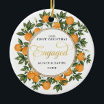 First Christmas Engaged Wedding Citrus Greenery Ceramic Ornament<br><div class="desc">This citrus inspired Christmas ornament features beautiful hand-painted oranges and lush greenery. Great for a summer wedding!. The text fields are fully editable except for the word "Engaged". Simply remove this word by clicking the delete button and add your own text if you require a different word.</div>