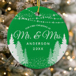 First Christmas Mr Mrs Green Winter String Lights Ceramic Ornament<br><div class="desc">Celebrate the newlyweds' first Christmas with this charming ceramic ornament. The design features a green winter string lights backdrop with the words "Mr. & Mrs." in a classic script. This personalized keepsake makes a thoughtful wedding or housewarming gift. The high-quality ornament comes ready to hang and is sure to be...</div>