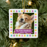 First Christmas Pet Puppy Photo Paws Multicolor Ceramic Ornament<br><div class="desc">“My First Christmas.” Celebrate your new pet’s arrival this past year! A purple plum banner with your pet’s name and year in whimsical white typography overlays your puppy or kitten’s custom photo. A playful border of multicolor purple, pink, orange, yellow, turquoise and green paw prints against white surrounds it. Feel...</div>