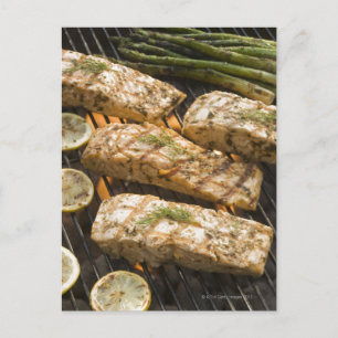 Fish and asparagus cooking on grill postcard