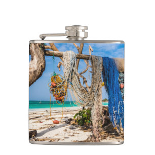 Fishing nets drying on the beach hip flask