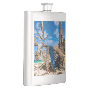 Fishing nets drying on the beach hip flask