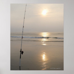 Fishing rod by the ocean in the early morning. poster
