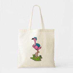 Flamant rose comme randonneur avec sac à dos